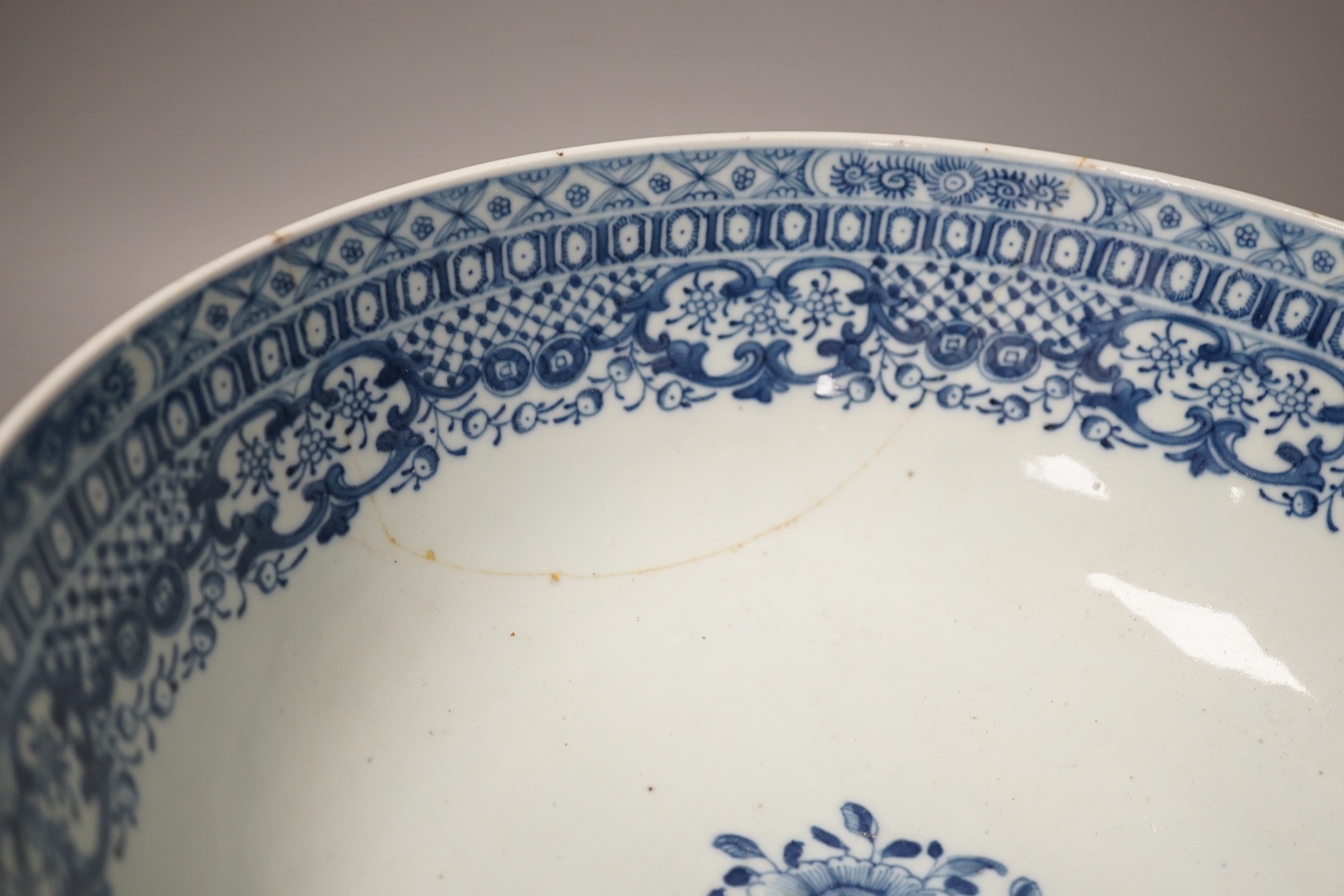 An 18th century Chinese blue and white punch bowl and similar plate. Largest 29cm
